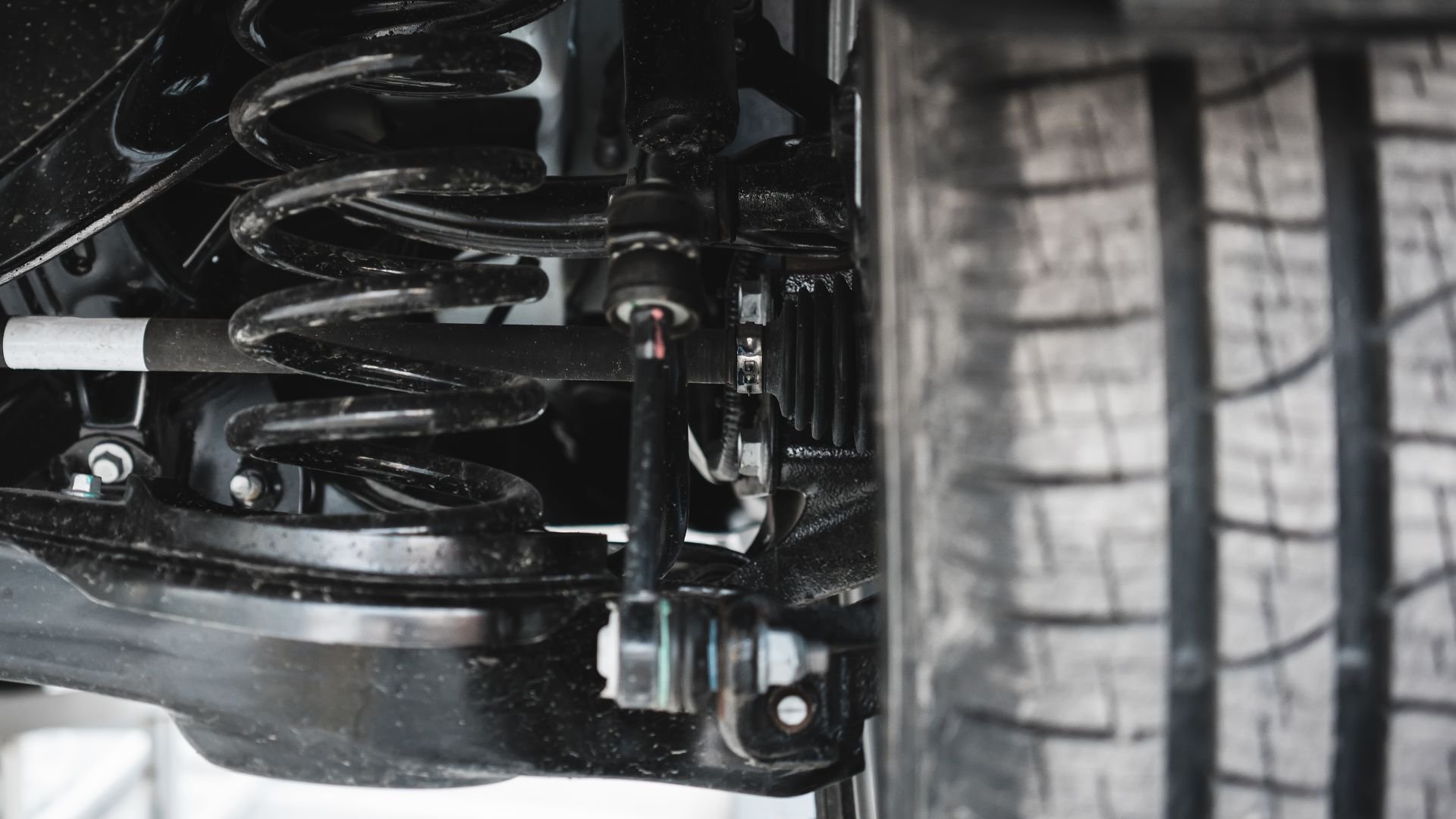 Close-up of vehicle suspension system with coil springs and mounting hardware