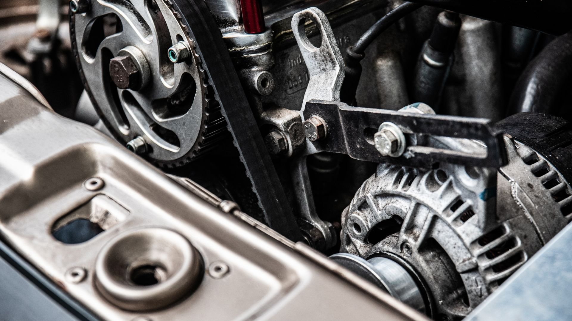 Close-up of car engine with metallic gears, bolts, and mechanical components